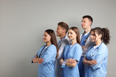 Photo of Group of medical students on light grey background. Space for text