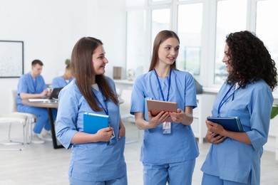 Photo of Medical students in uniforms indoors, selective focus
