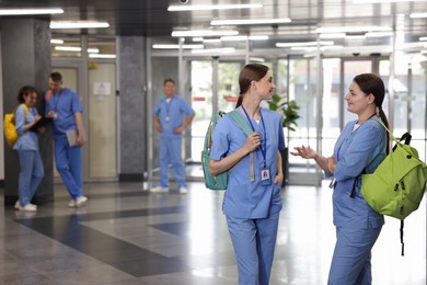 Photo of Medical students in uniforms indoors, selective focus