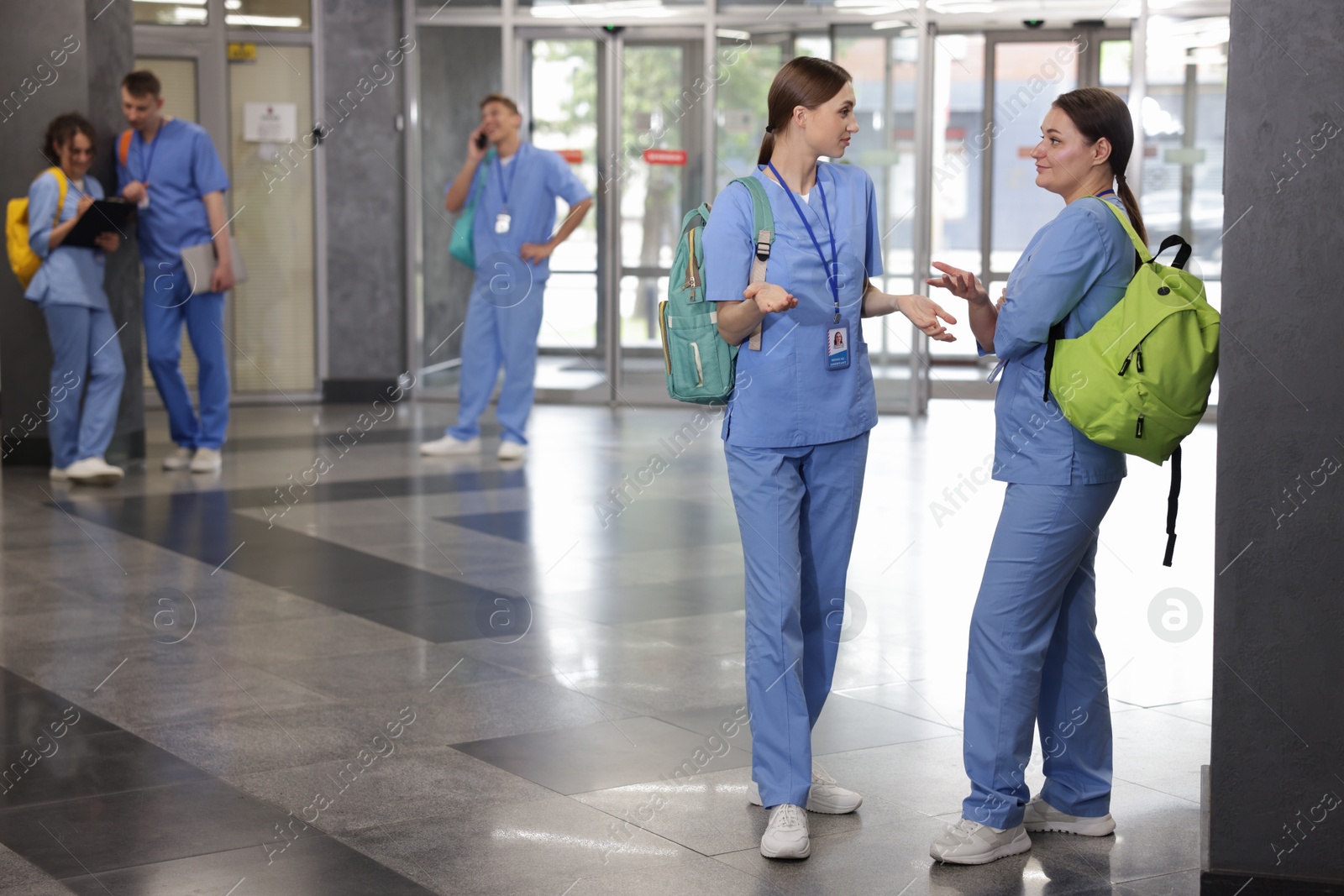 Photo of Medical students in uniforms indoors, selective focus