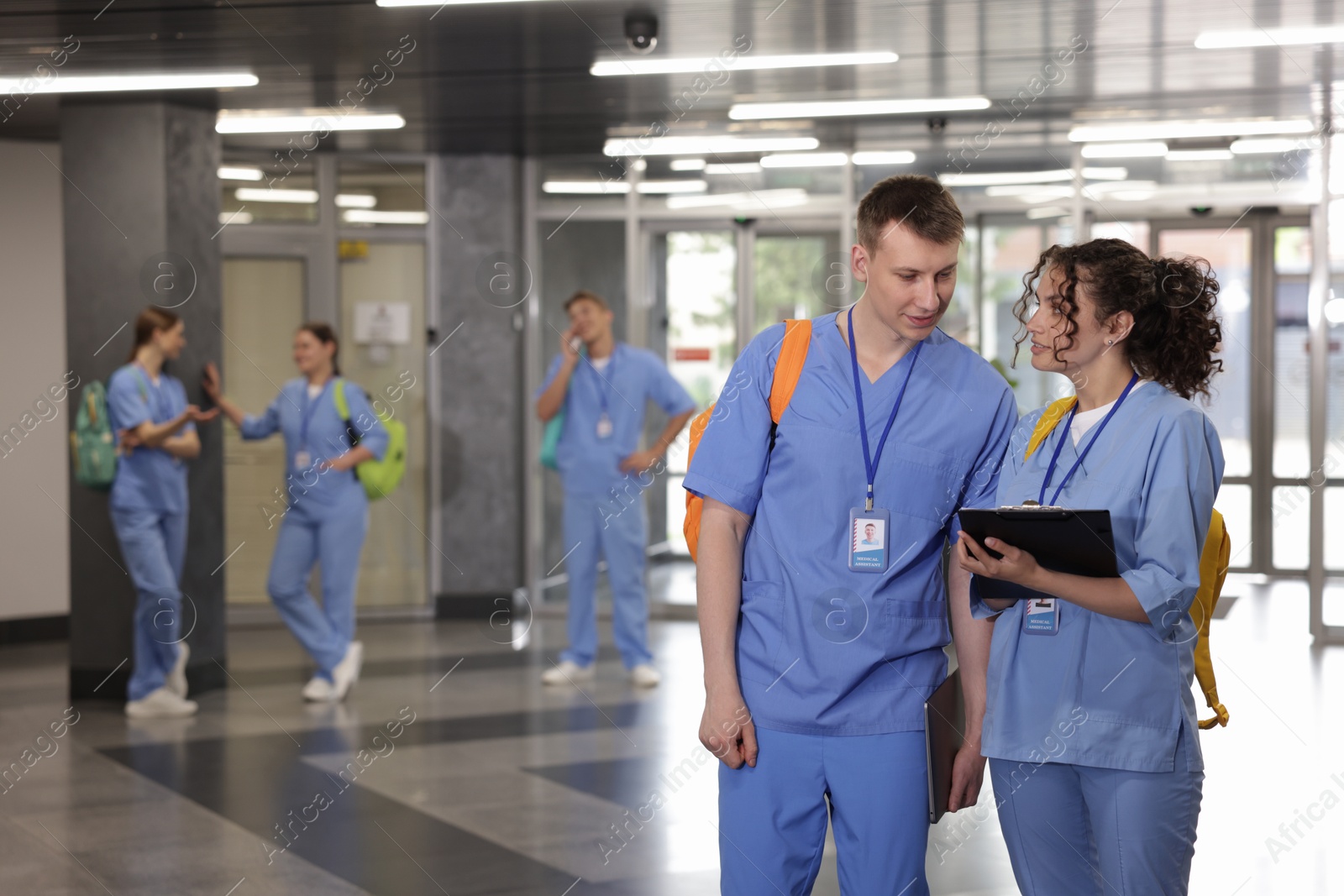 Photo of Medical students in uniforms indoors, selective focus