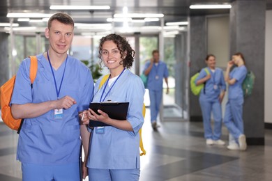 Photo of Medical students in uniforms indoors, selective focus