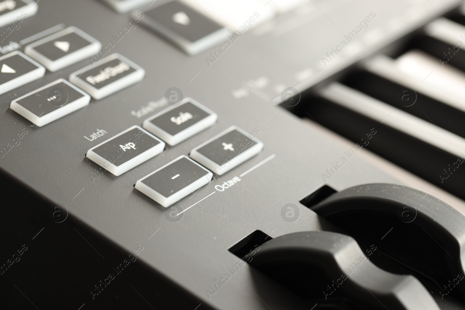 MIDI keyboard with buttons and faders, closeup Photo of MIDI keyboard with buttons and faders, closeup