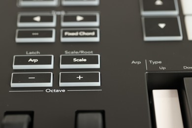 Photo of One portable MIDI keyboard with buttons, closeup
