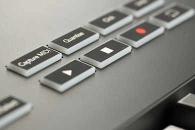 Photo of One portable MIDI keyboard with buttons, closeup