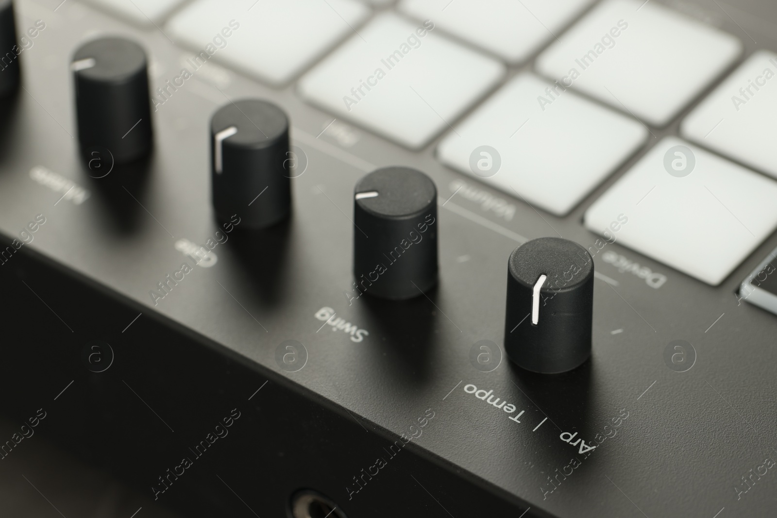 MIDI keyboard with buttons and faders, closeup Photo of MIDI keyboard with buttons and faders, closeup