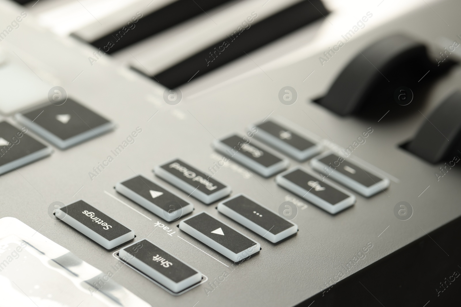 MIDI keyboard with buttons and faders, closeup Photo of MIDI keyboard with buttons and faders, closeup
