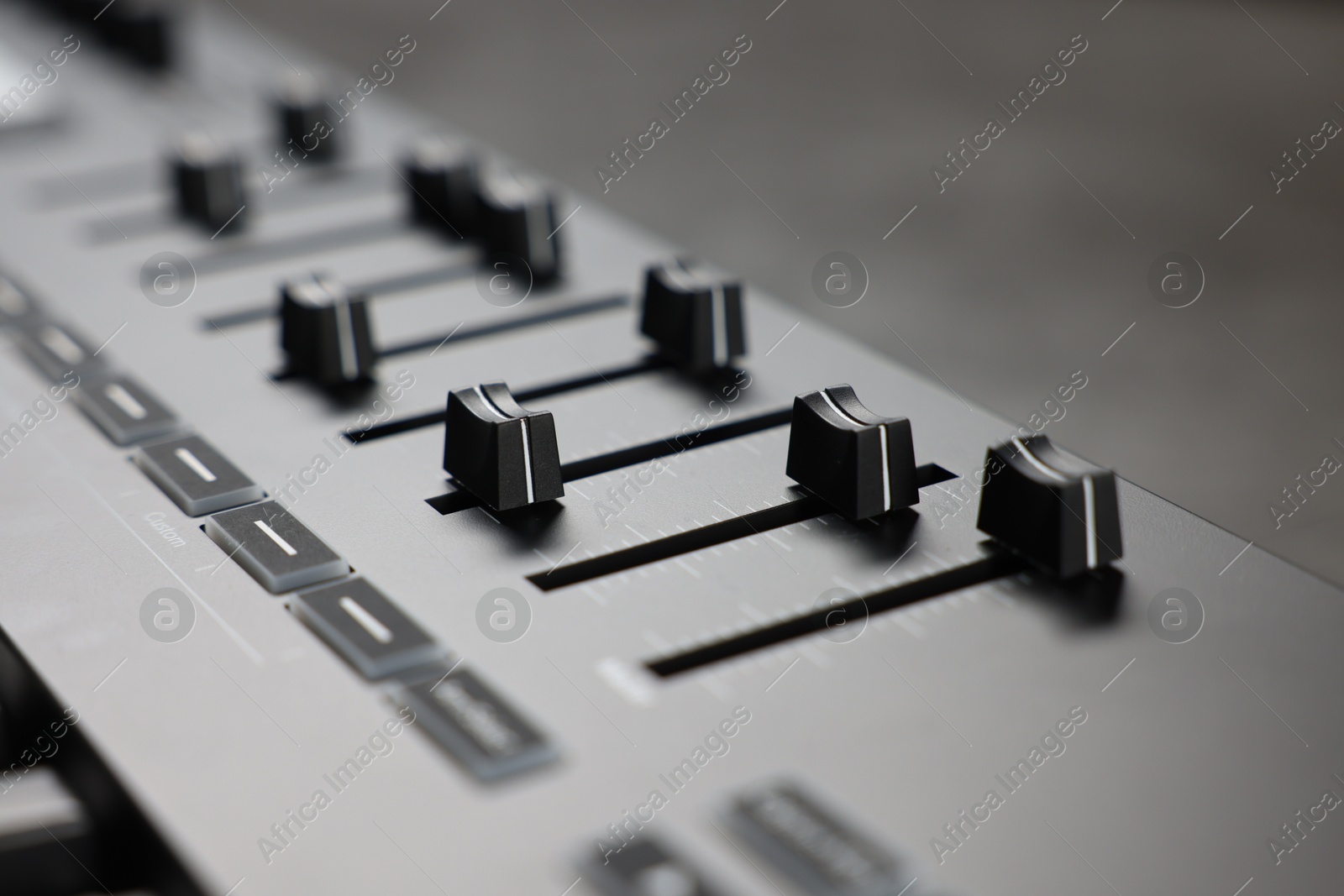 MIDI keyboard with faders on table, closeup Photo of MIDI keyboard with faders on table, closeup
