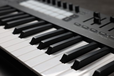 Photo of One portable MIDI keyboard on table, closeup