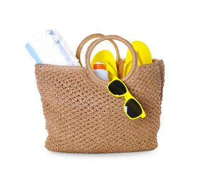 Photo of Stylish bag with beach accessories isolated on white
