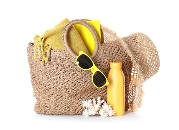 Photo of Stylish bag with beach accessories isolated on white