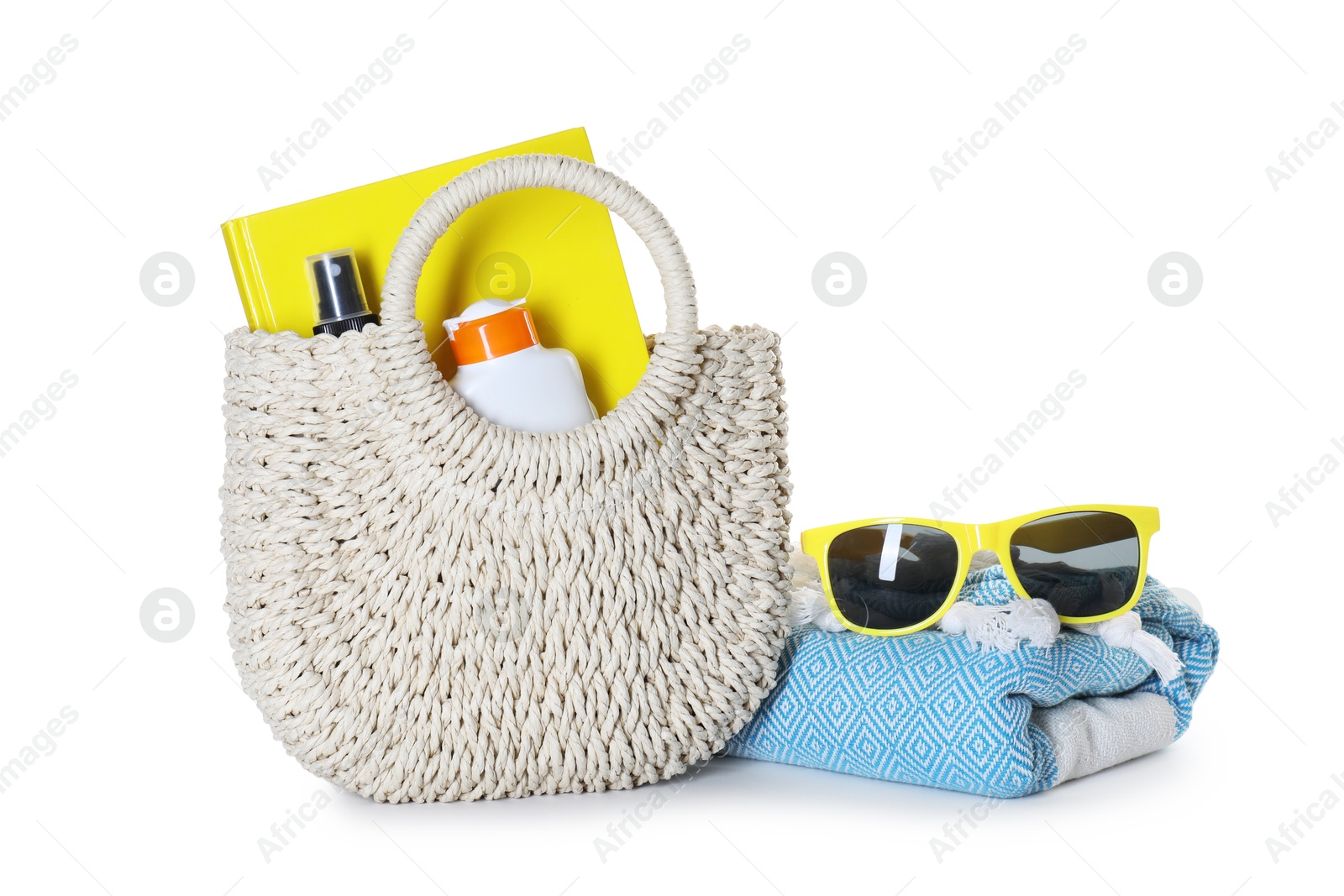 Stylish bag with beach accessories isolated on white Photo of Stylish bag with beach accessories isolated on white