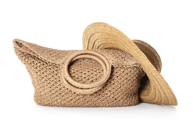 Photo of Stylish knitted beach bag and wicker hat isolated on white