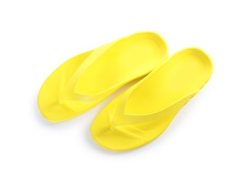 Photo of Yellow flip-flops isolated on white, top view. Beach accessory