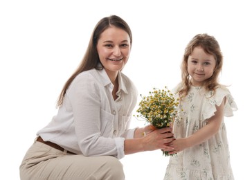 Photo of Mother and her little daughter with bouquet of beautiful chamomile flowers on white background