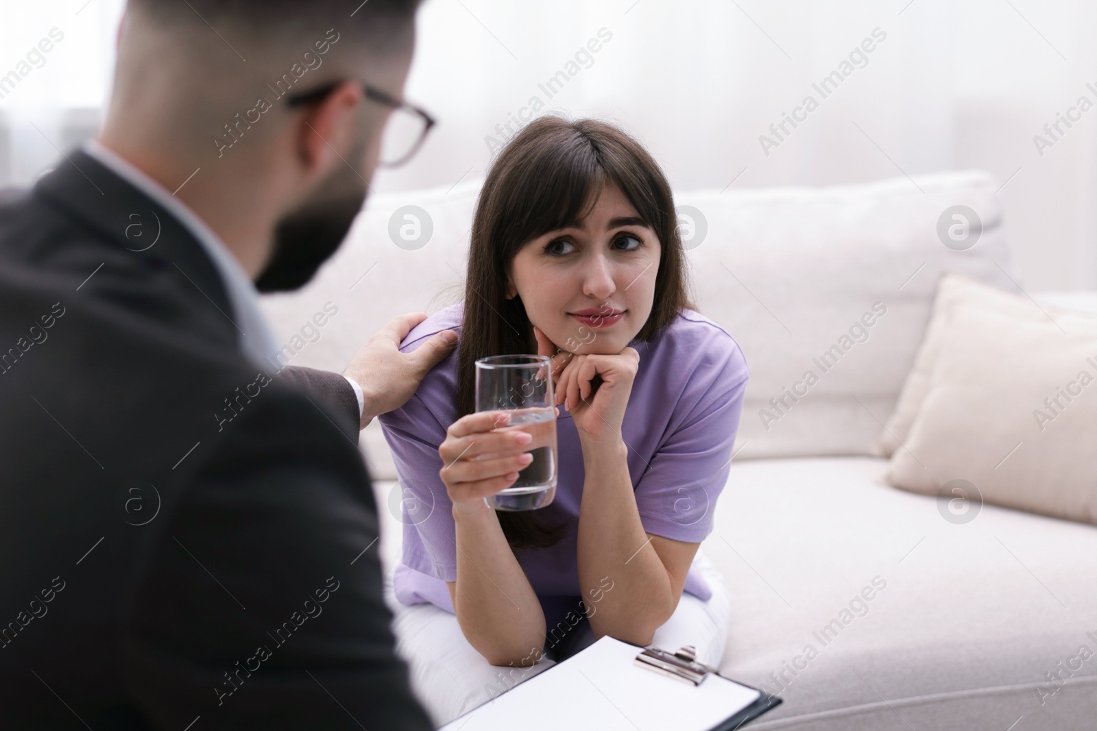 Psychologist supporting patient during therapy session in office, selective focus Photo of Psychologist supporting patient during therapy session in office, selective focus