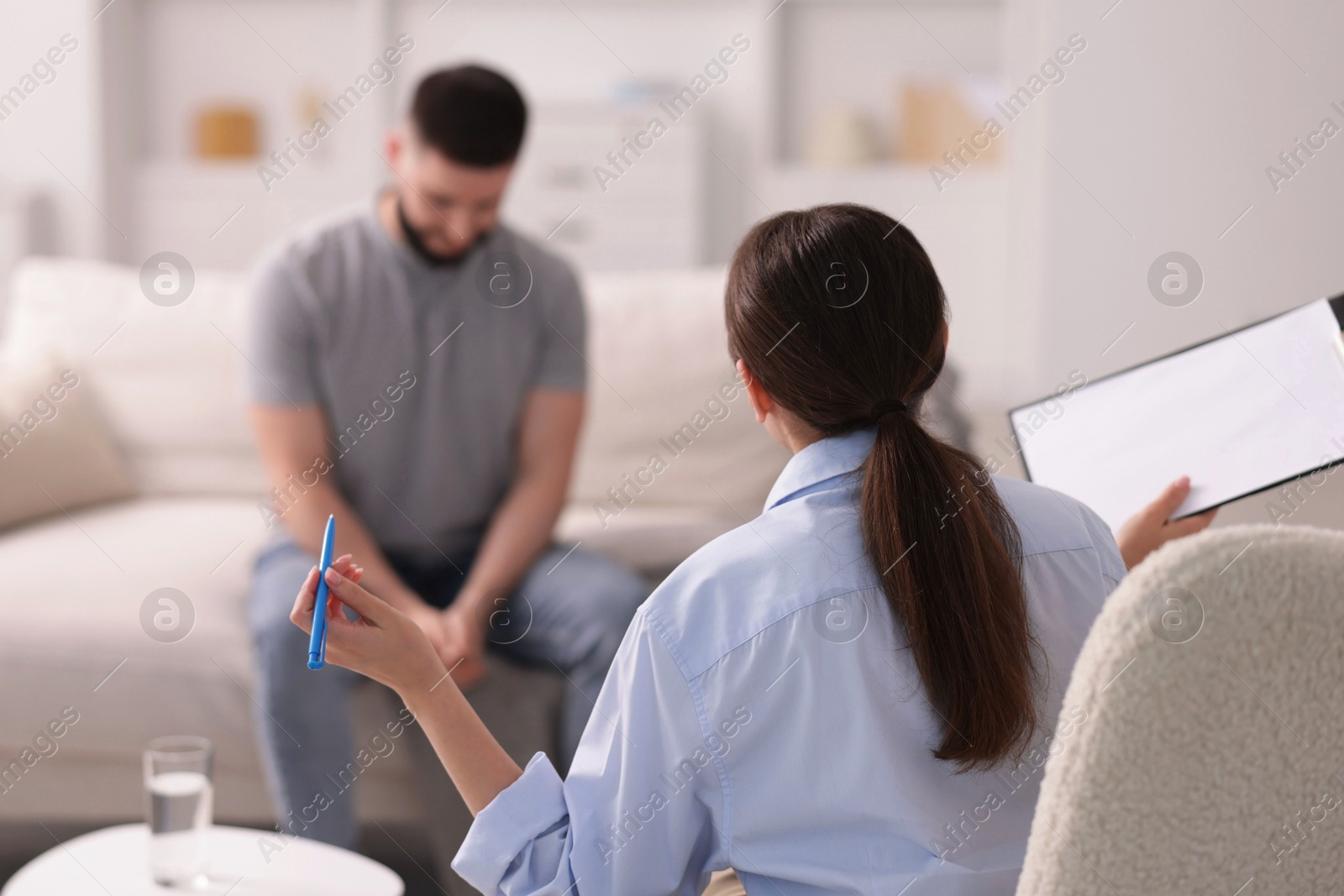Photo of Professional psychologist working with patient in office, selective focus