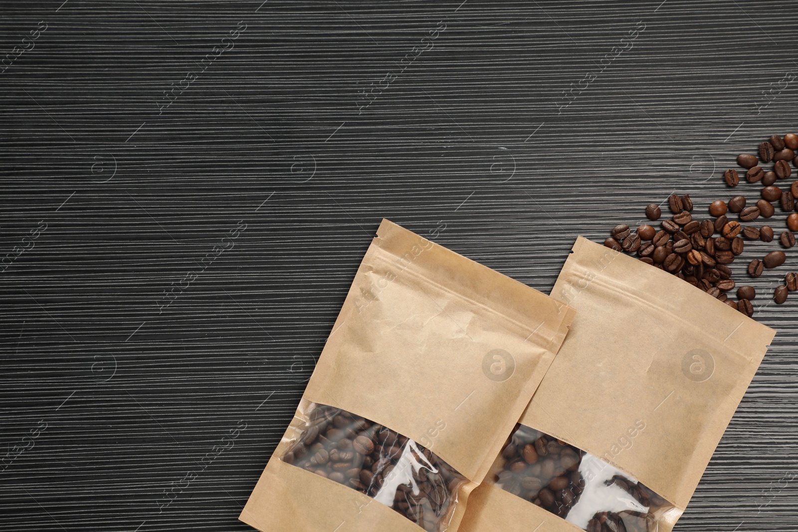 Zipper stand-up pouches and coffee beans on black textured table, flat lay. Mockup for design Photo of Zipper stand-up pouches and coffee beans on black textured table, flat lay. Mockup for design