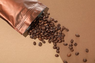 Photo of Zipper stand-up pouch and coffee beans on color background, flat lay