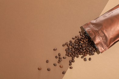 Photo of Zipper stand-up pouch and coffee beans on color background, flat lay. Space for text