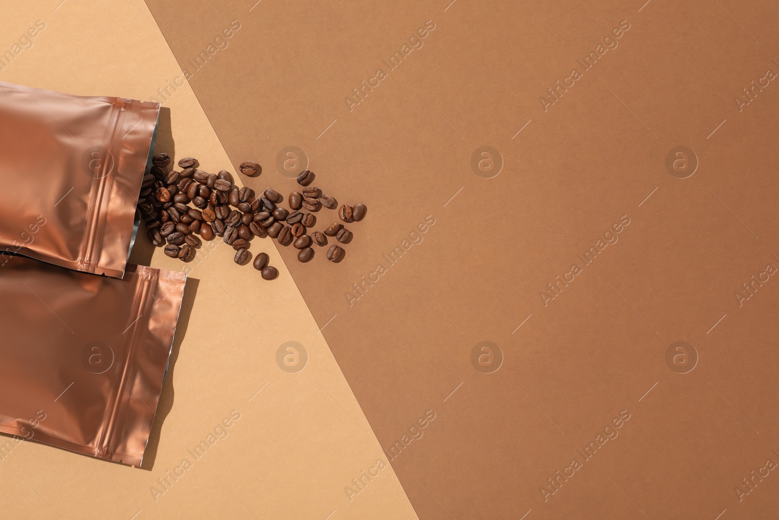 Zipper stand-up pouches and coffee beans on color background, flat lay. Space for text Photo of Zipper stand-up pouches and coffee beans on color background, flat lay. Space for text