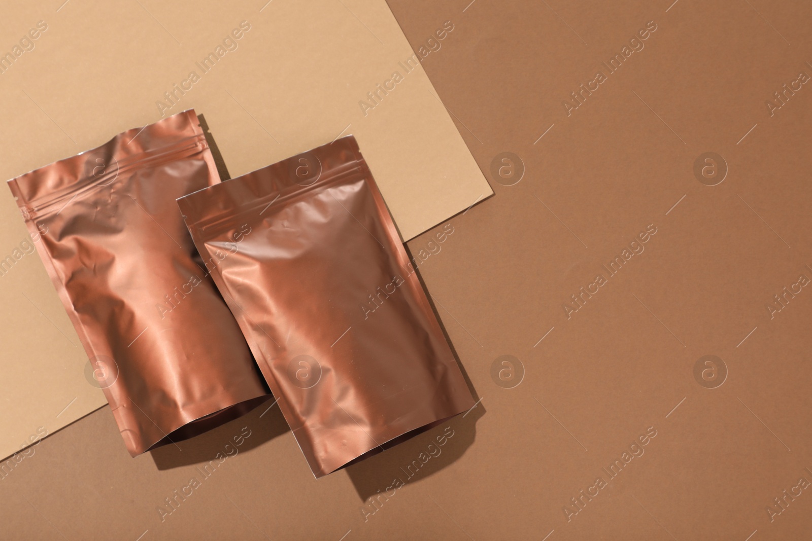 Photo of Zipper stand-up pouches on color background, flat lay. Mockup for design