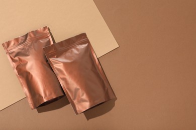 Photo of Zipper stand-up pouches on color background, flat lay. Mockup for design