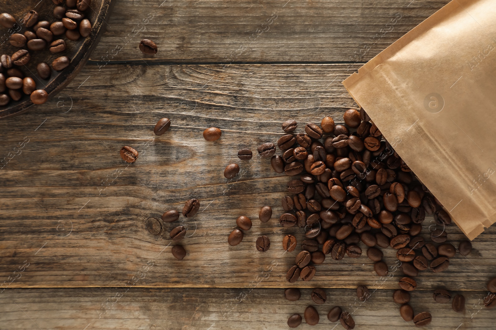 Zipper stand-up pouch with coffee beans on wooden table, flat lay Photo of Zipper stand-up pouch with coffee beans on wooden table, flat lay