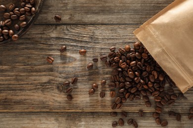 Photo of Zipper stand-up pouch with coffee beans on wooden table, flat lay