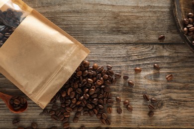 Photo of Zipper stand-up pouch with coffee beans on wooden table, flat lay. Mockup for design