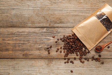 Photo of Zipper stand-up pouch with coffee beans on wooden table, flat lay. Mockup for design
