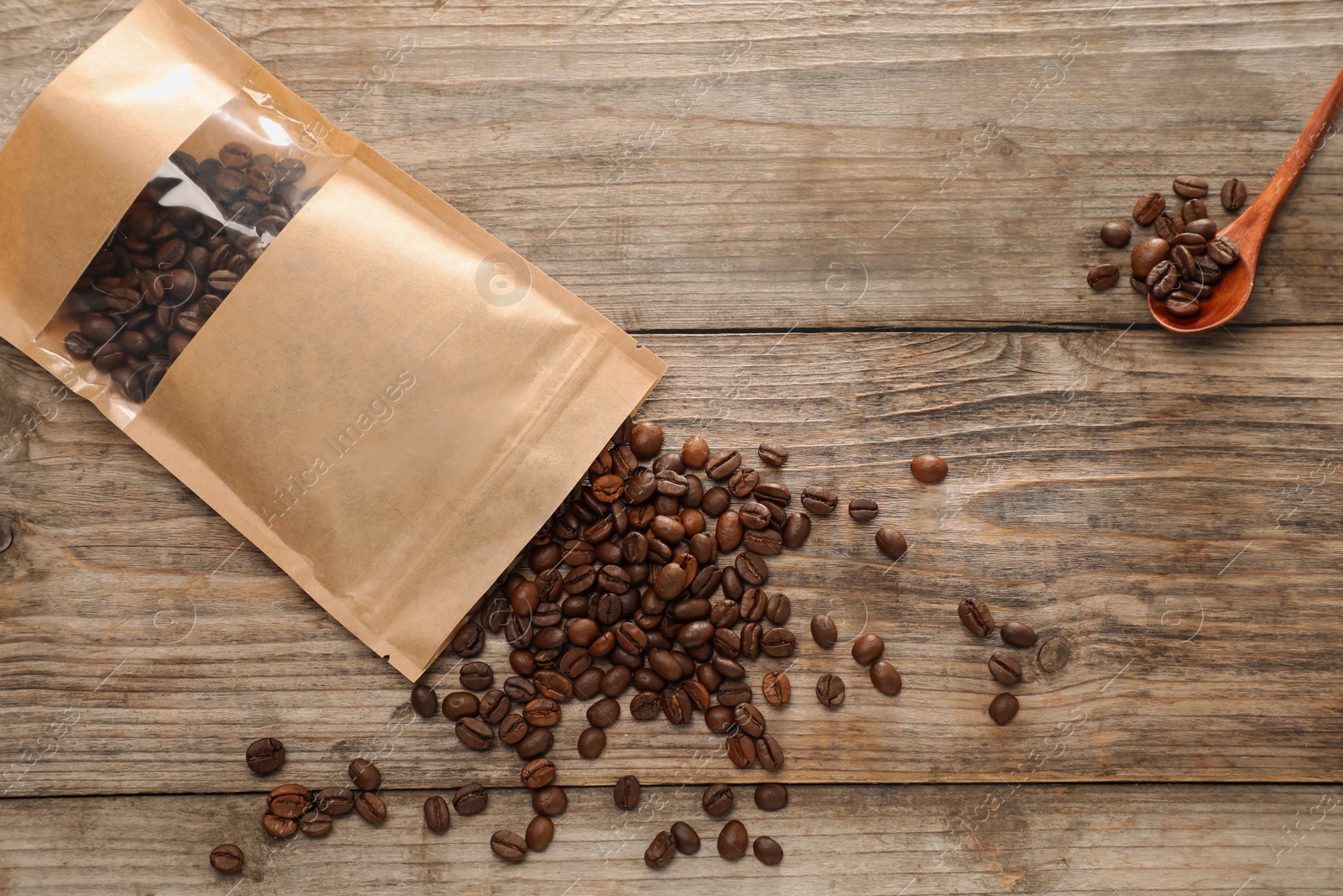 Zipper stand-up pouch with coffee beans on wooden table, flat lay. Mockup for design Photo of Zipper stand-up pouch with coffee beans on wooden table, flat lay. Mockup for design
