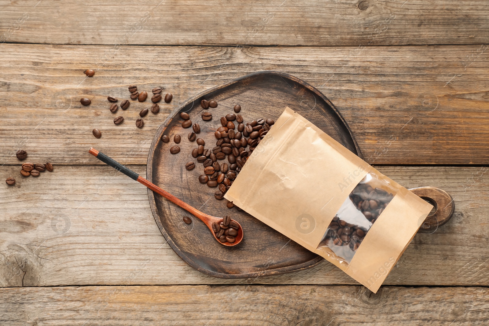 Zipper stand-up pouch with coffee beans on wooden table, flat lay. Mockup for design Photo of Zipper stand-up pouch with coffee beans on wooden table, flat lay. Mockup for design