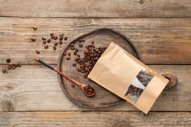 Photo of Zipper stand-up pouch with coffee beans on wooden table, flat lay. Mockup for design