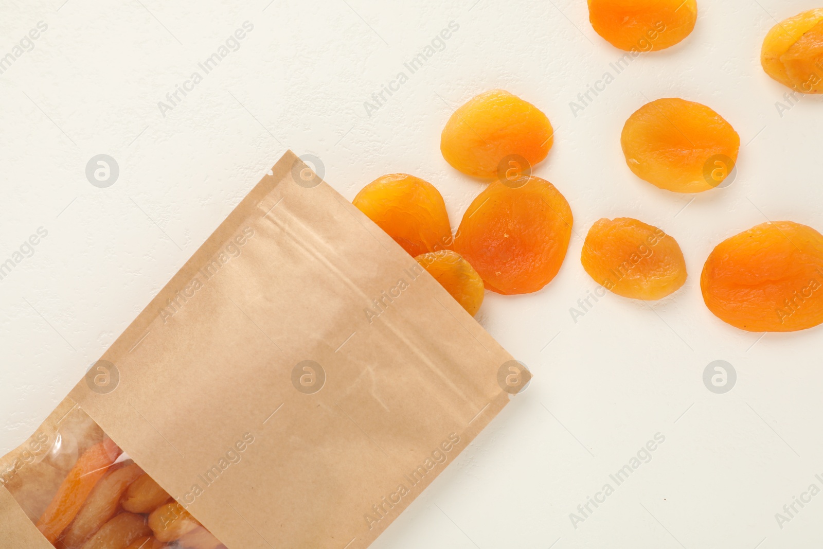 Zipper stand-up pouch with dried apricots on white table, flat lay. Mockup for design Photo of Zipper stand-up pouch with dried apricots on white table, flat lay. Mockup for design