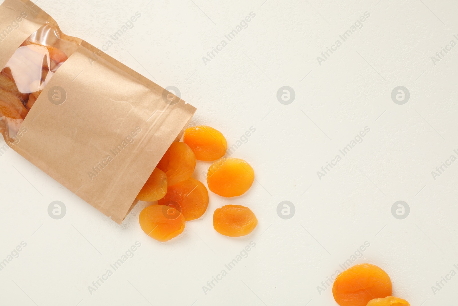 Zipper stand-up pouch with dried apricots on white table, flat lay. Mockup for design Photo of Zipper stand-up pouch with dried apricots on white table, flat lay. Mockup for design