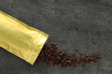 Photo of Zipper stand-up pouch and coffee beans on grey table, flat lay. Mockup for design