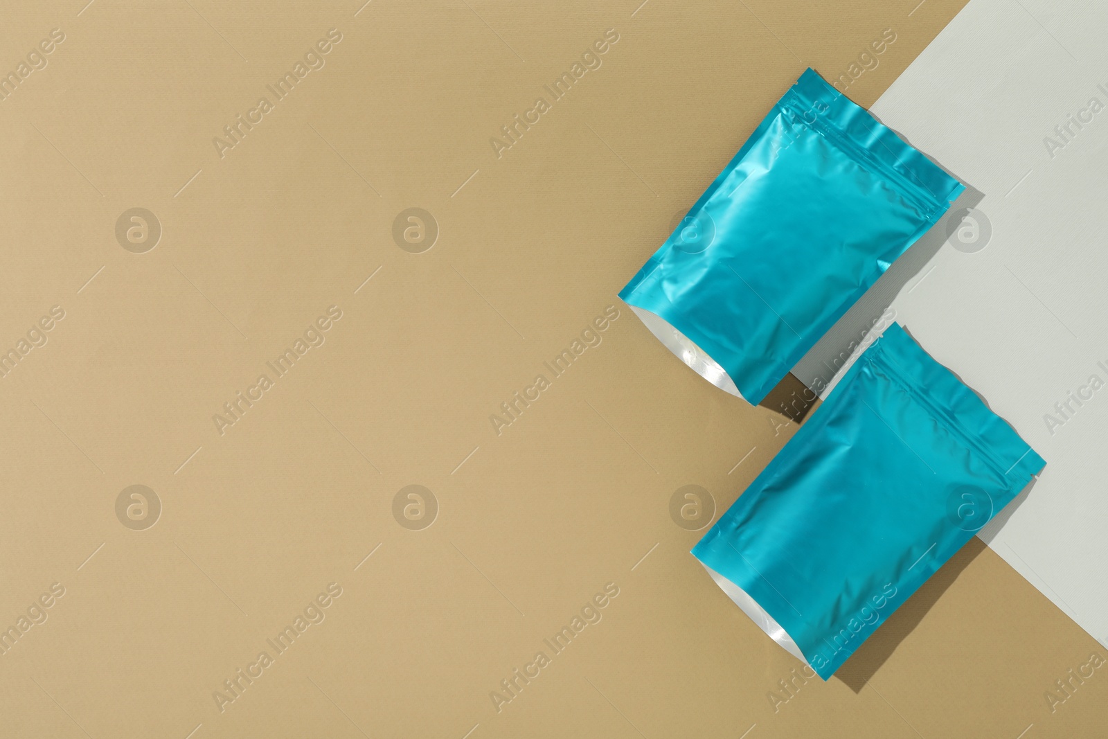 Zipper stand-up pouches on color background, flat lay. Mockup for design Photo of Zipper stand-up pouches on color background, flat lay. Mockup for design