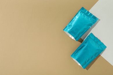 Photo of Zipper stand-up pouches on color background, flat lay. Mockup for design