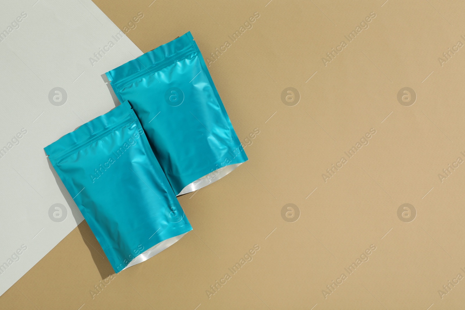 Zipper stand-up pouches on color background, flat lay. Mockup for design Photo of Zipper stand-up pouches on color background, flat lay. Mockup for design