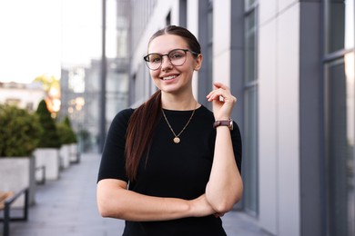 Photo of Portrait of successful businesswoman near office building