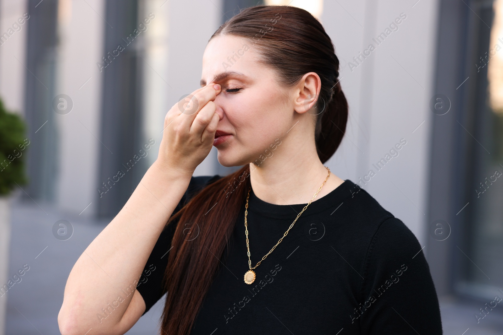 Portrait of tired businesswoman outside office building Photo of Portrait of tired businesswoman outside office building