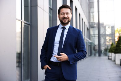 Photo of Portrait of successful businessman near office building