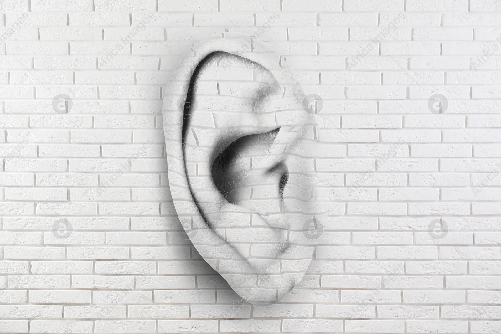Human ear in white brick wall. Eavesdropping, concept that even walls have ears Image of Human ear in white brick wall. Eavesdropping, concept that even walls have ears