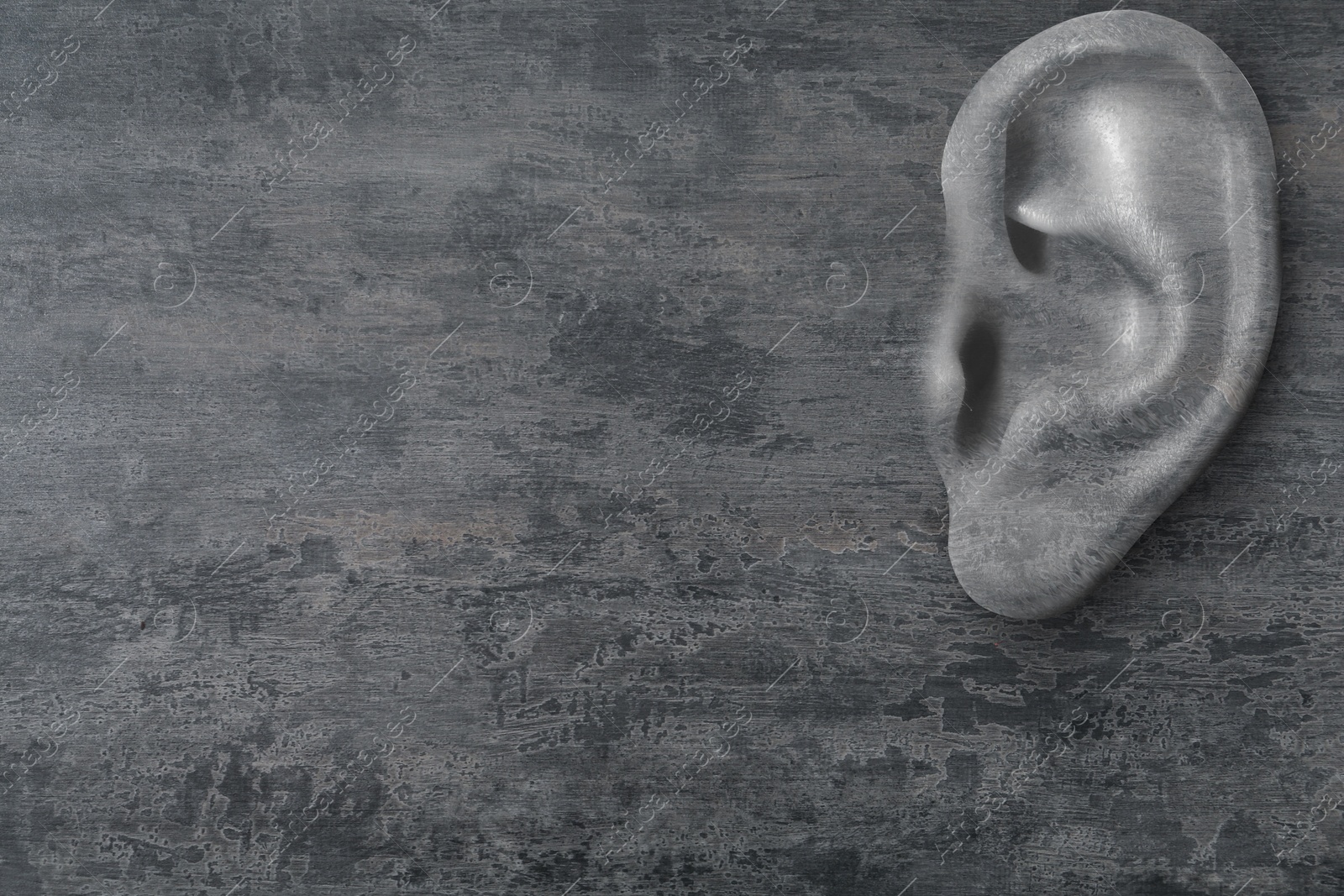 Image of Human ear in grey stone wall, space for text. Eavesdropping, concept that even walls have ears