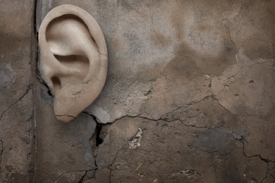 Image of Human ear in old stone wall. Eavesdropping, concept that even walls have ears