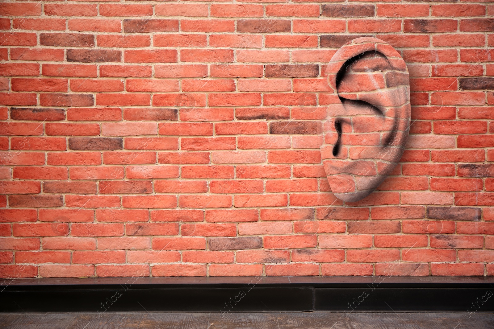 Image of Human ear in red brick wall, space for text. Eavesdropping, concept that even walls have ears