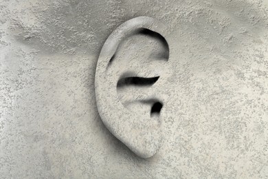 Image of Human ear in grey wall. Eavesdropping, concept that even walls have ears