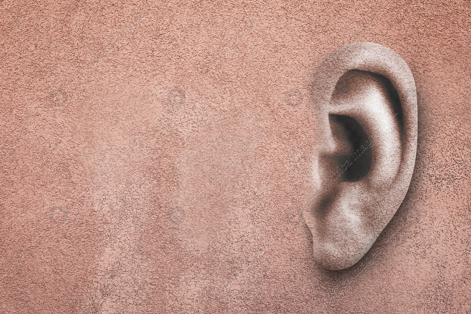Image of Human ear in pink plaster wall, space for text. Eavesdropping, concept that even walls have ears