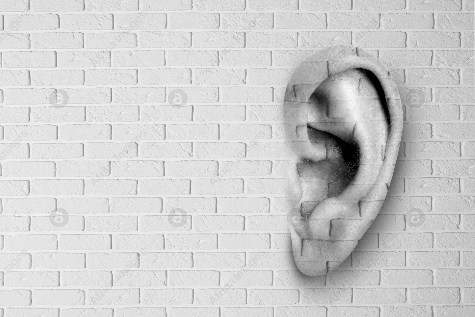 Image of Human ear in white brick wall, space for text. Eavesdropping, concept that even walls have ears